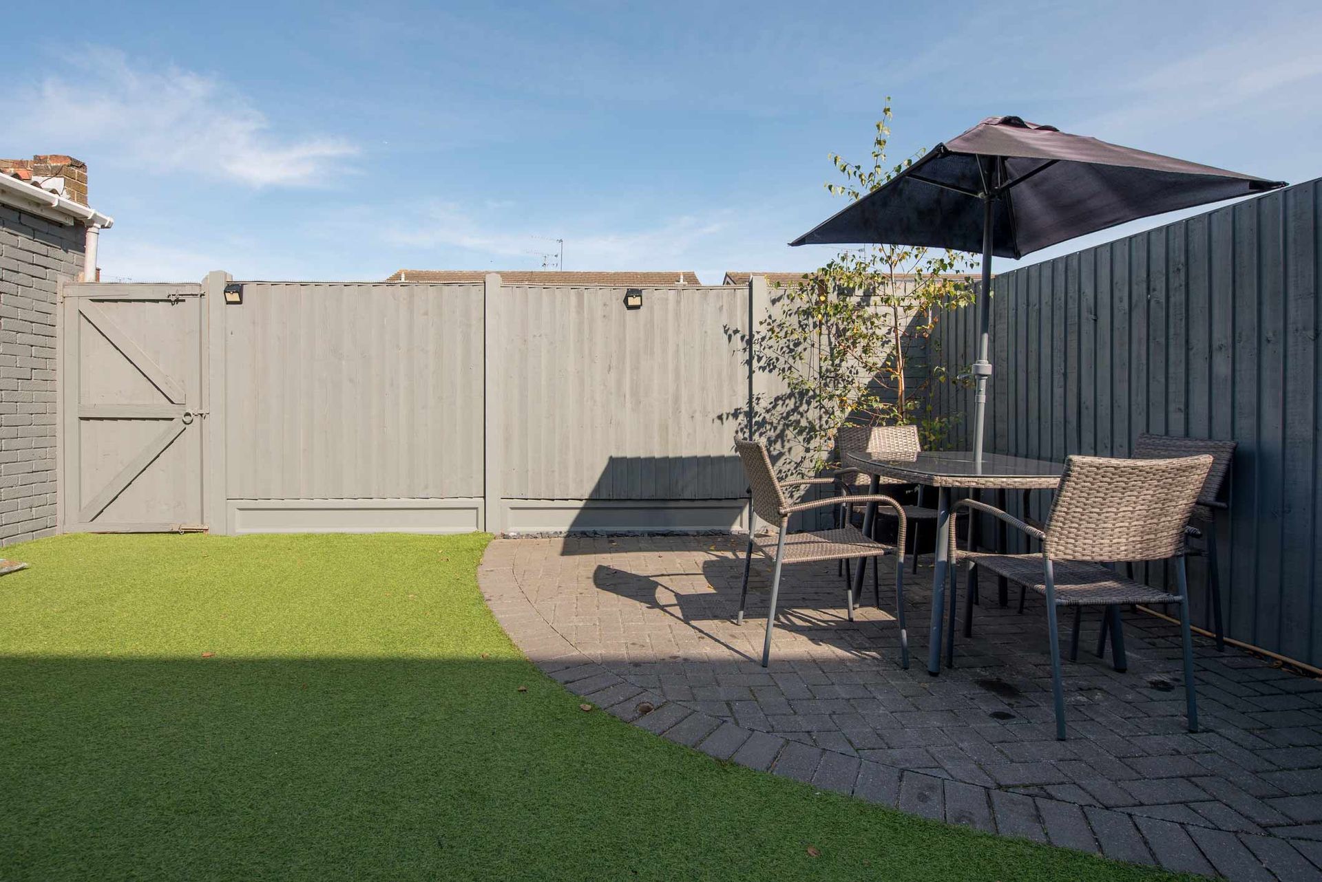 A Backyard with A Table and Chairs and An Umbrella | Cranbourne, VIC | Cranbourne Fencing Pty Ltd