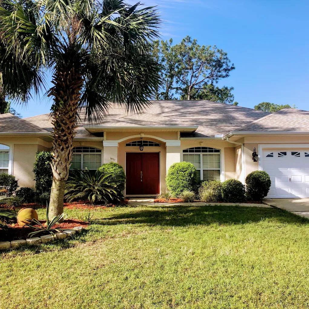 A house with a palm tree in front of it