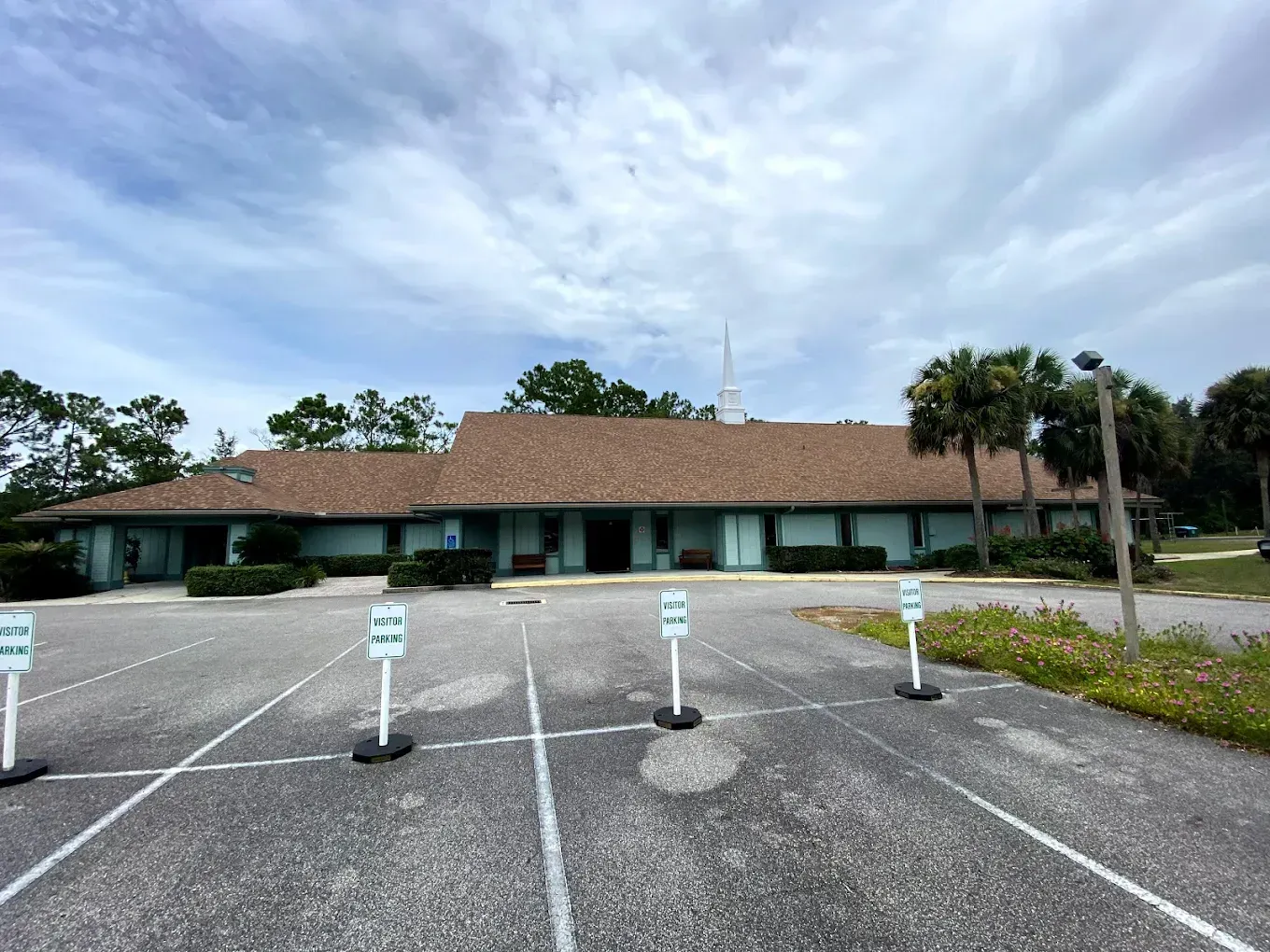 A large building with a lot of parking spaces in front of it