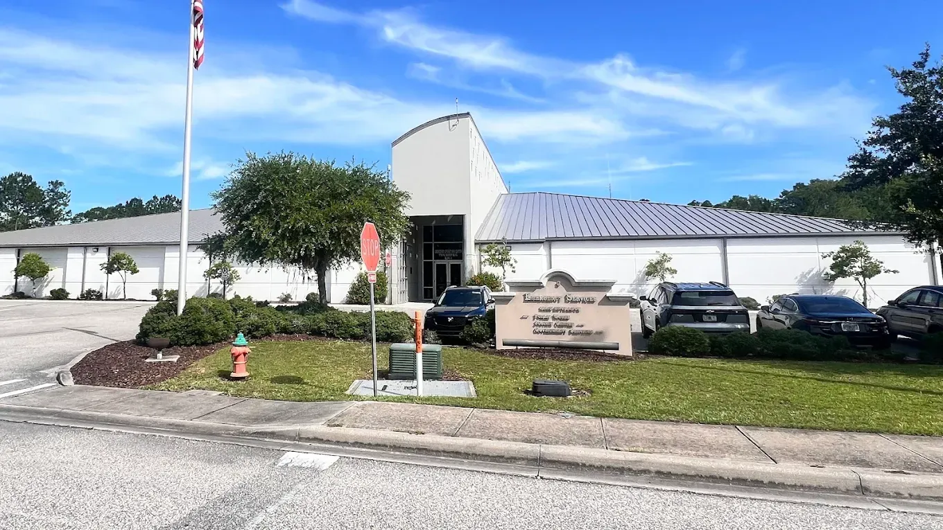 A large white building with a fire hydrant in front of it