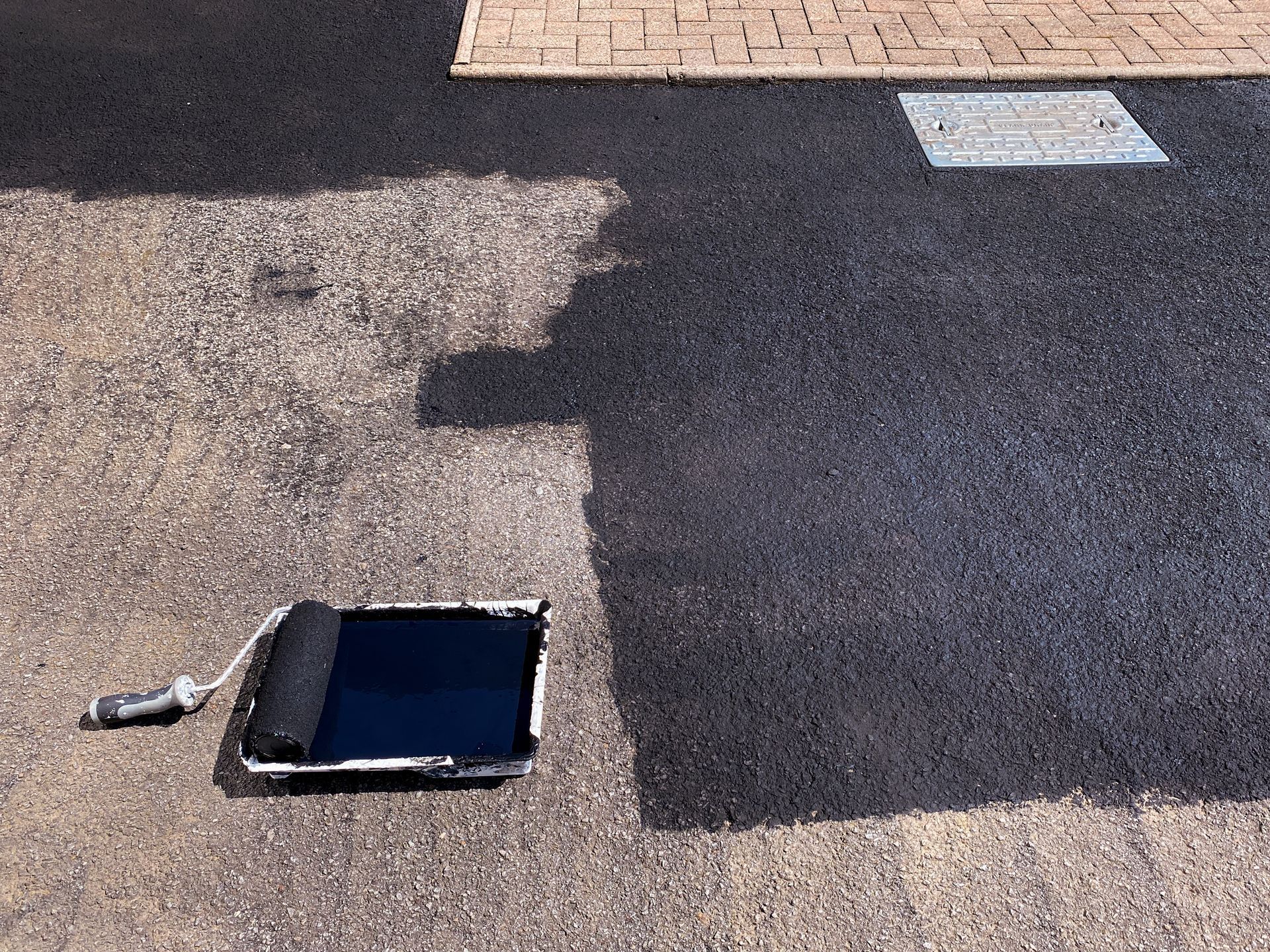 A tablet is laying on the ground next to a roller.