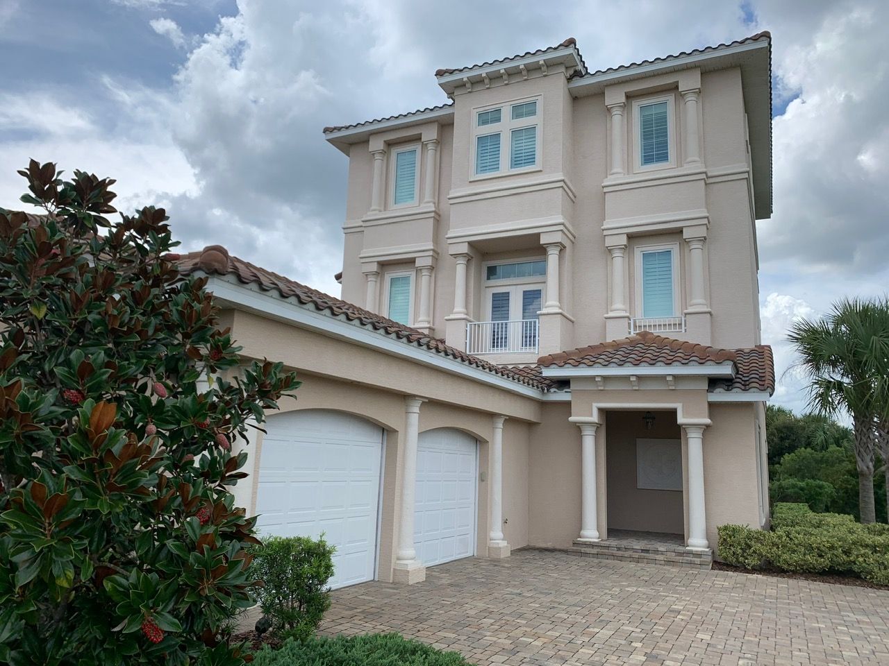A wooden ladder is sitting in a room next to a paint can.