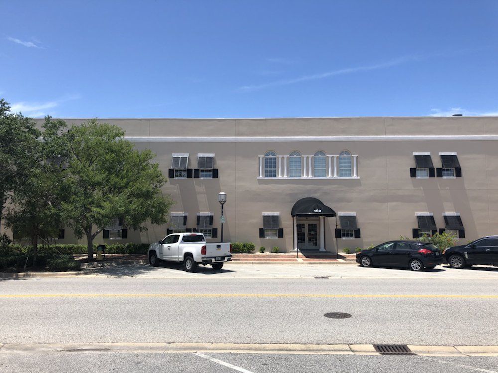 A large building with cars parked in front of it.