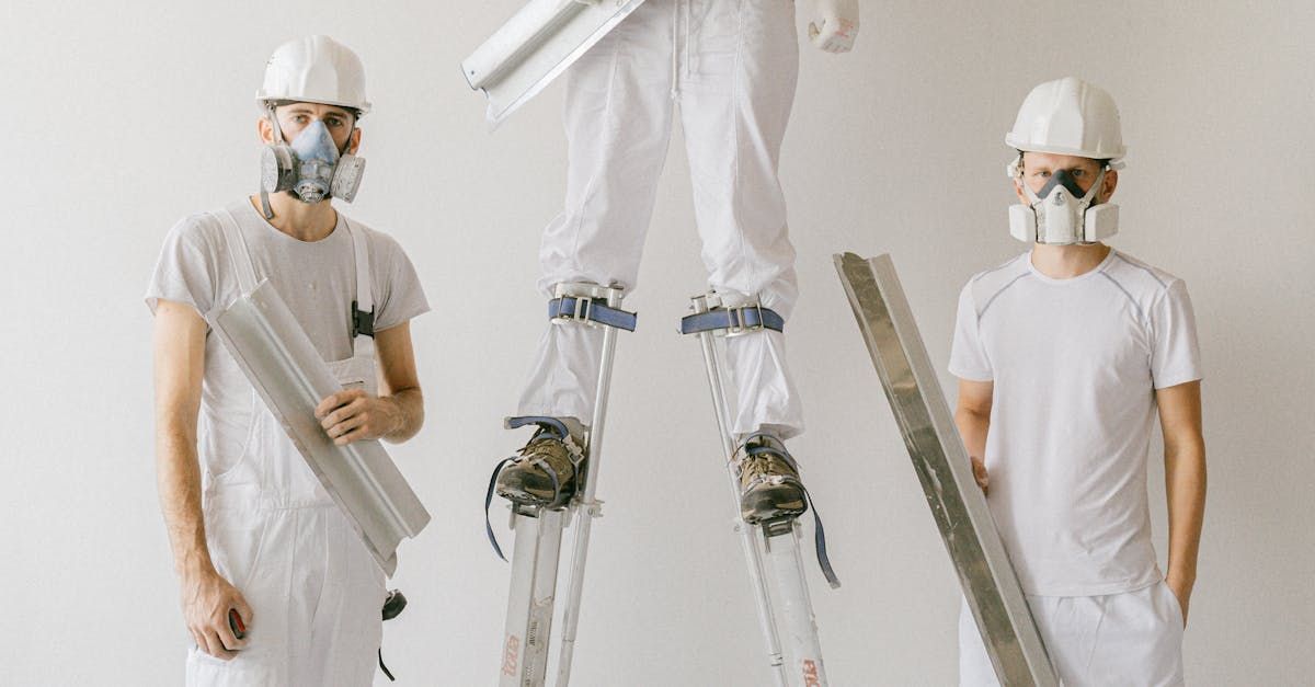 A group of construction workers wearing masks and hard hats are standing next to each other.