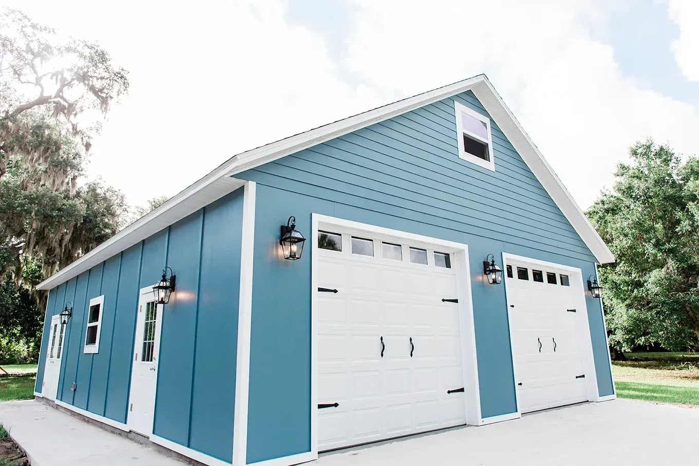 A blue and white garage with two garage doors.