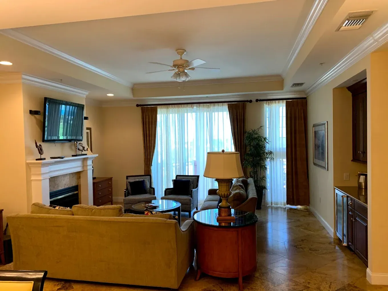A living room with a couch , chairs , a fireplace and a television.