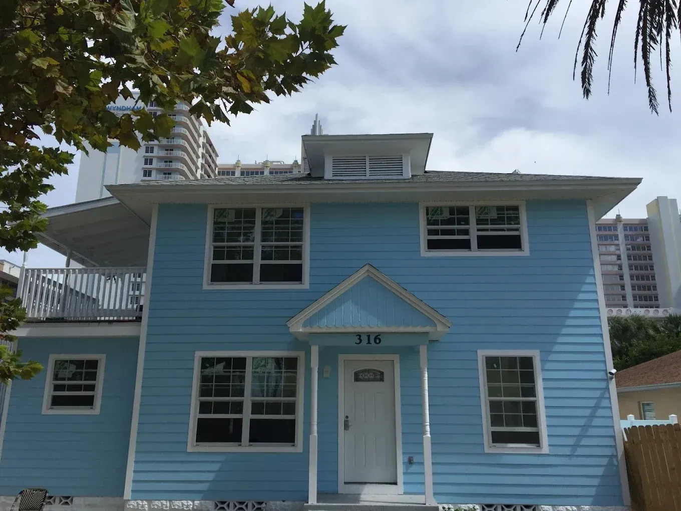 A blue house with the number 319 on the front