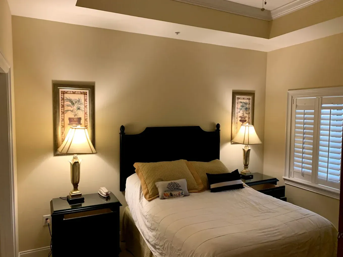 A bedroom with a bed and two lamps