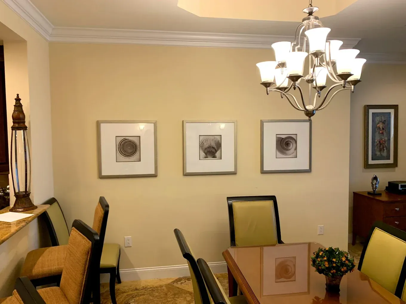 A dining room with a table and chairs and a chandelier