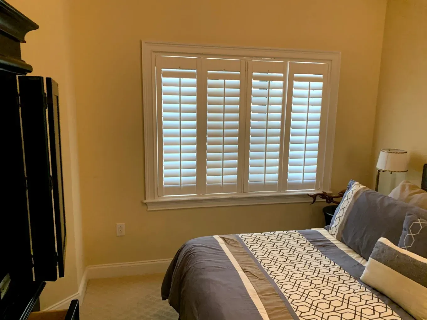 A large yellow house with a blue sky in the background