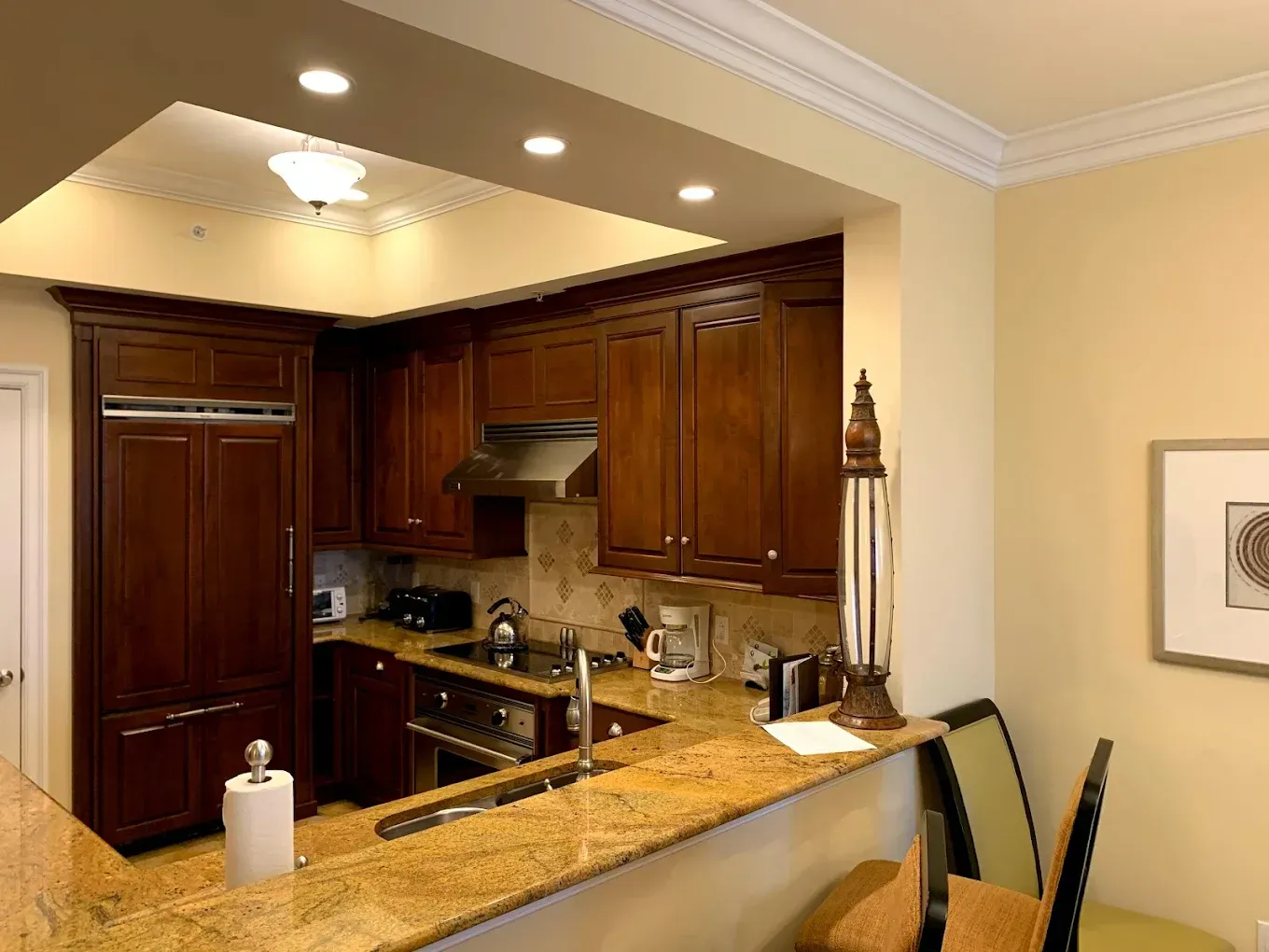 A kitchen with wooden cabinets and granite counter tops