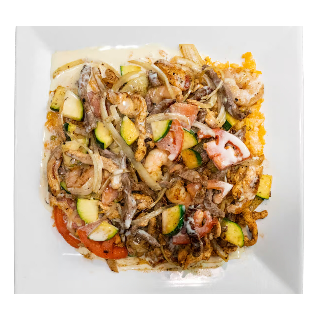 A white plate topped with a variety of vegetables and meat.