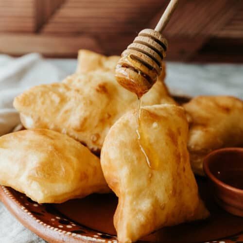 A plate of food with honey being poured on it