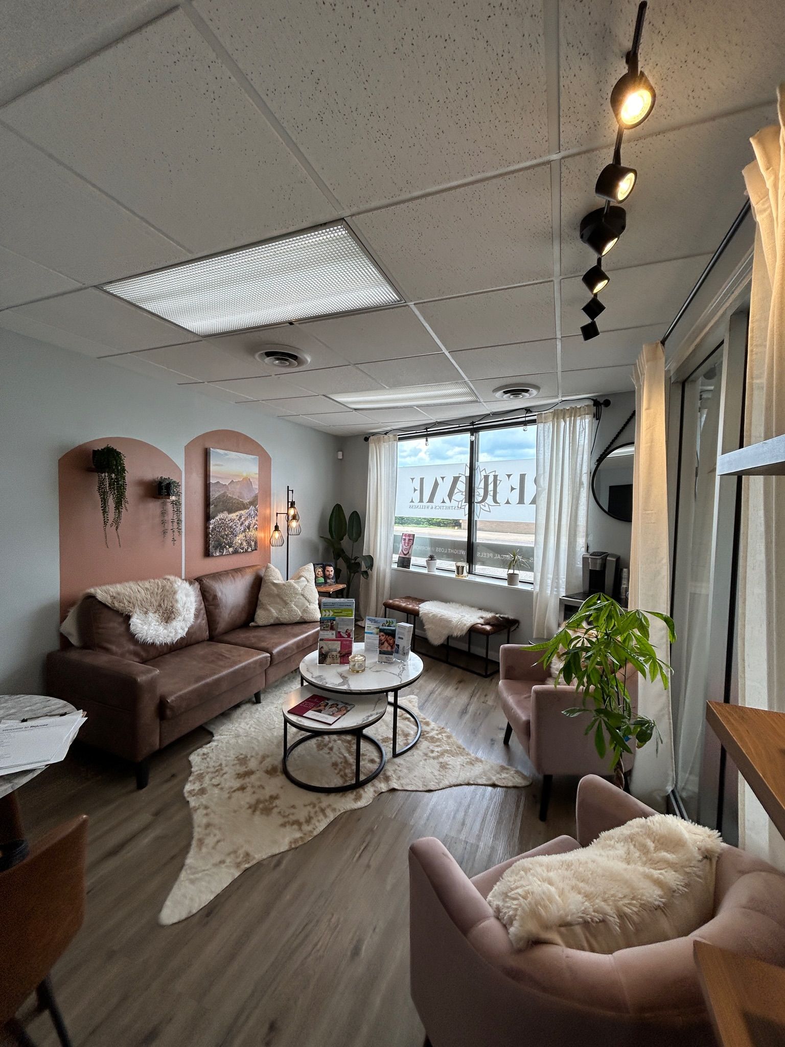 A living room with a couch , chairs , and a table.