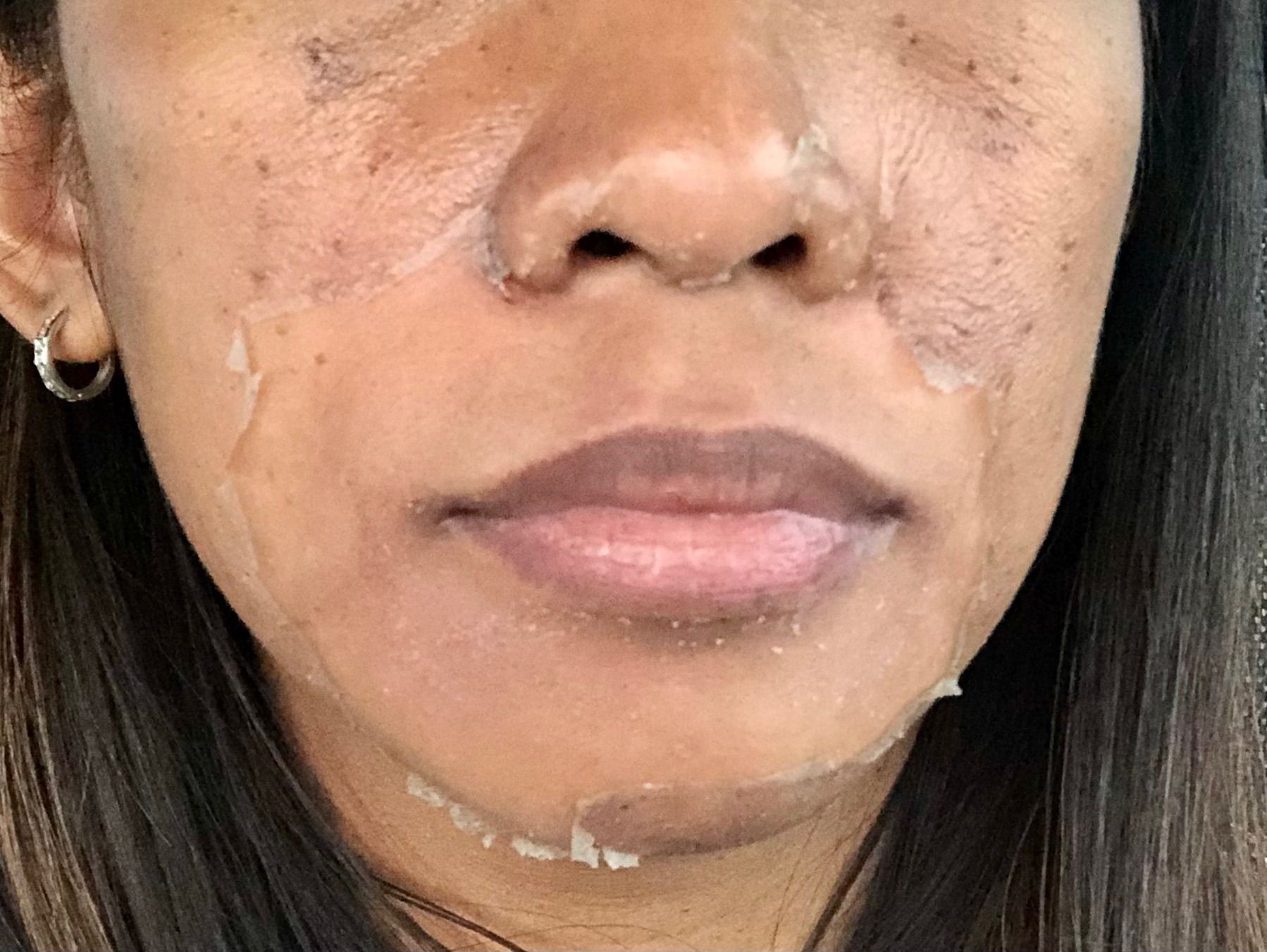 A close up of a woman 's face with a lot of makeup on it.