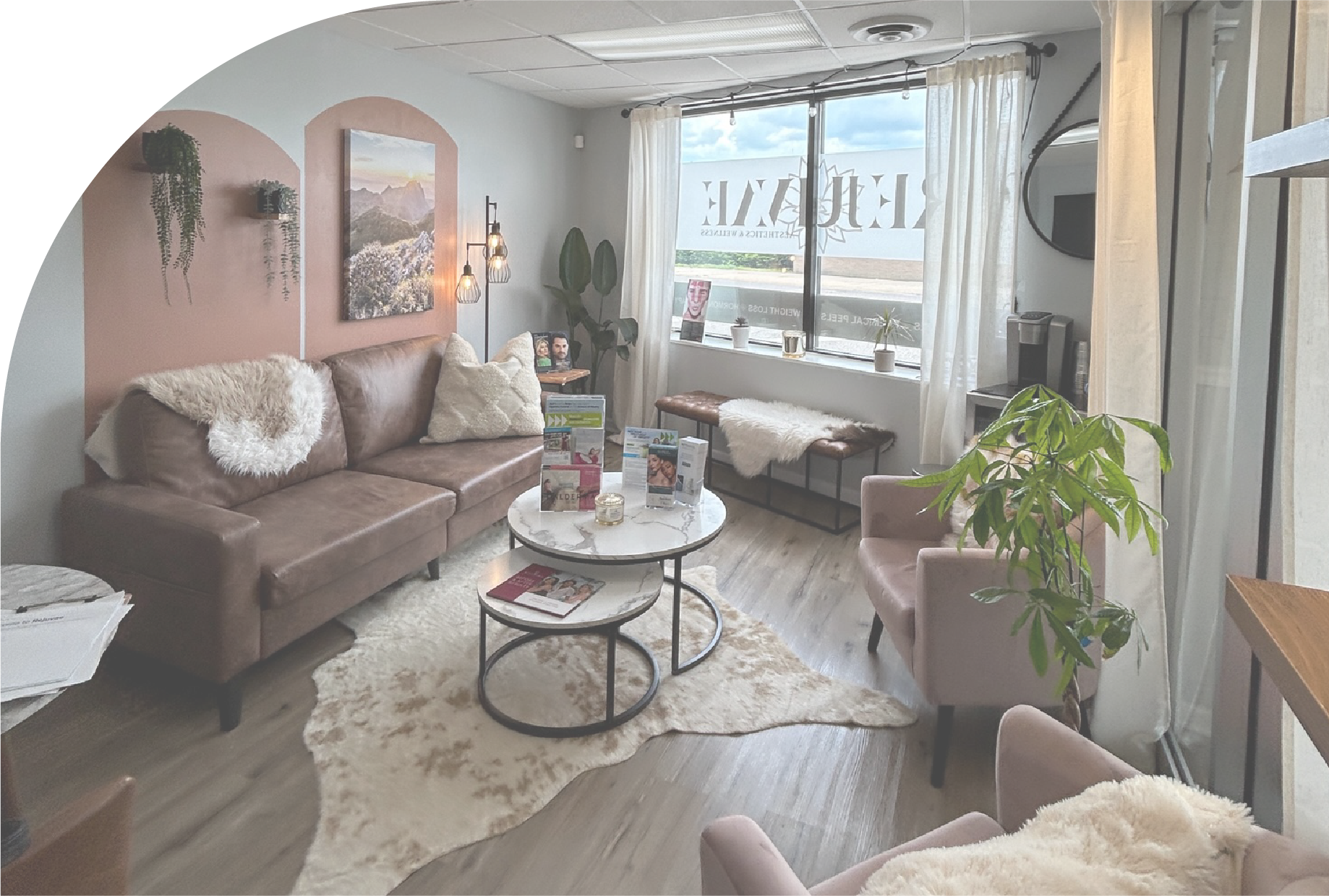 A living room with a couch , chairs , a table and a window.