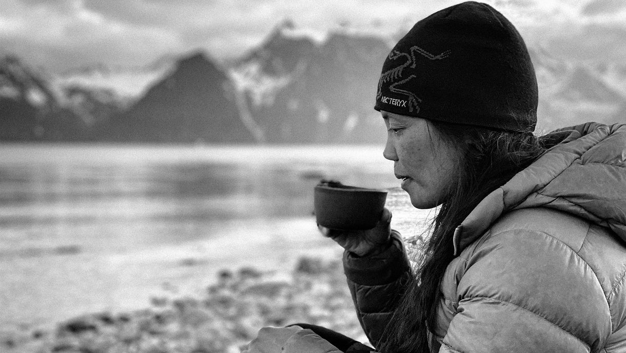 Yahnny drinking coffee on the beach in Lyngen Alps, Norway