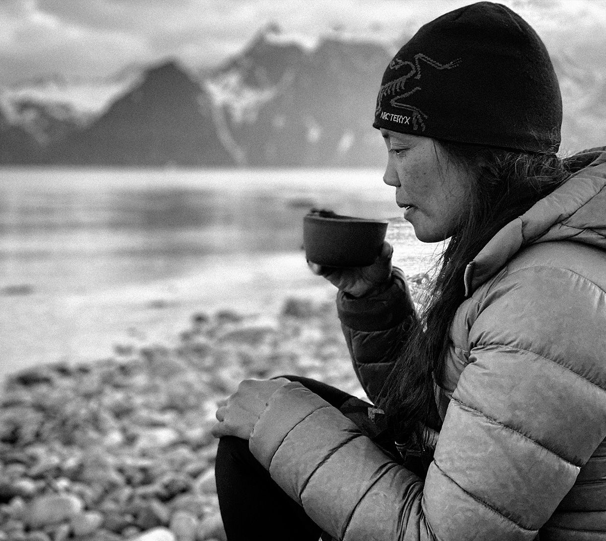 Yahnny having a cup of coffee on the beach in Lyngen Alps, Norway