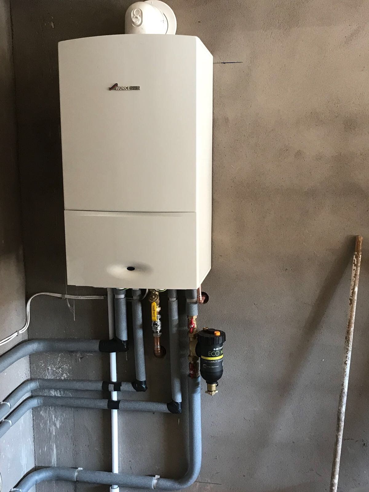 An efficient boiler installed in a room, featuring modern controls and safety features.