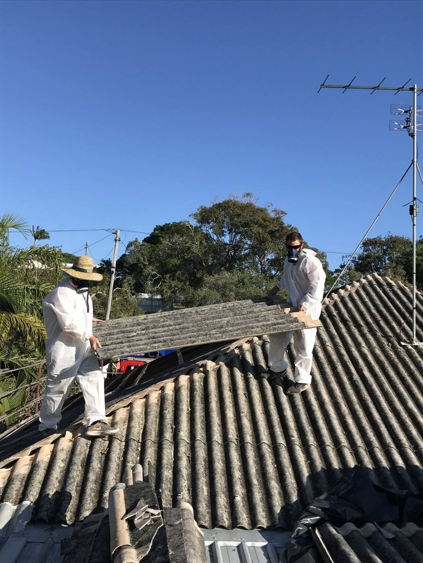 Stormguard Team With Protective Suit Removing Asbestos Roof — Stormguard Roofing In Caloundra West, QLD