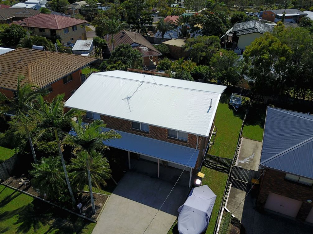 An Aerial View of a House With a White Roof — Stormguard Roofing In Sunshine Coast, QLD