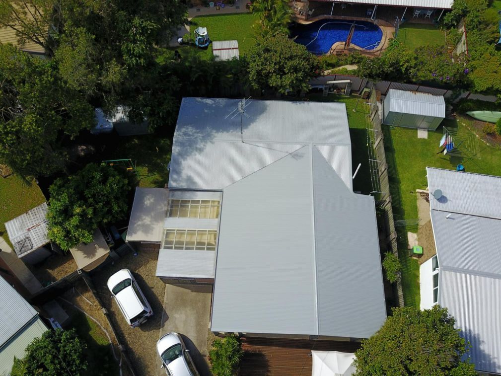 An Aerial View of a House With a Pool in the Backyard — Stormguard Roofing In Caloundra West, QLD