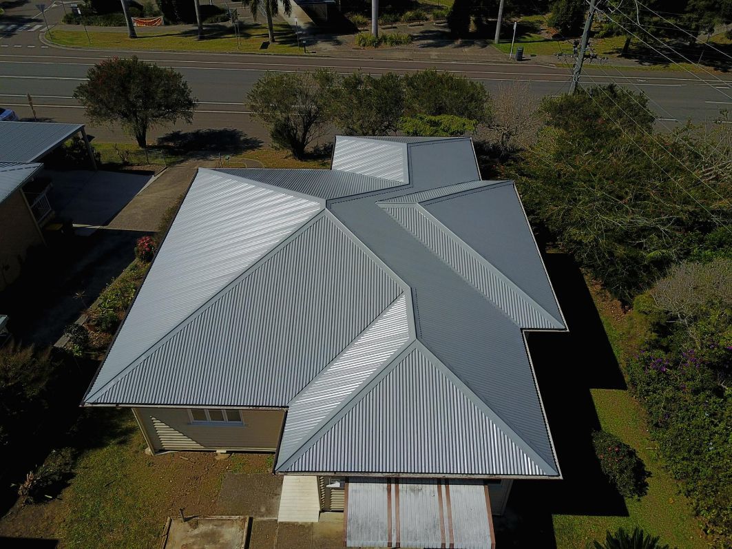 An Aerial View of a House With a Metal Roof — Stormguard Roofing In Caloundra West, QLD
