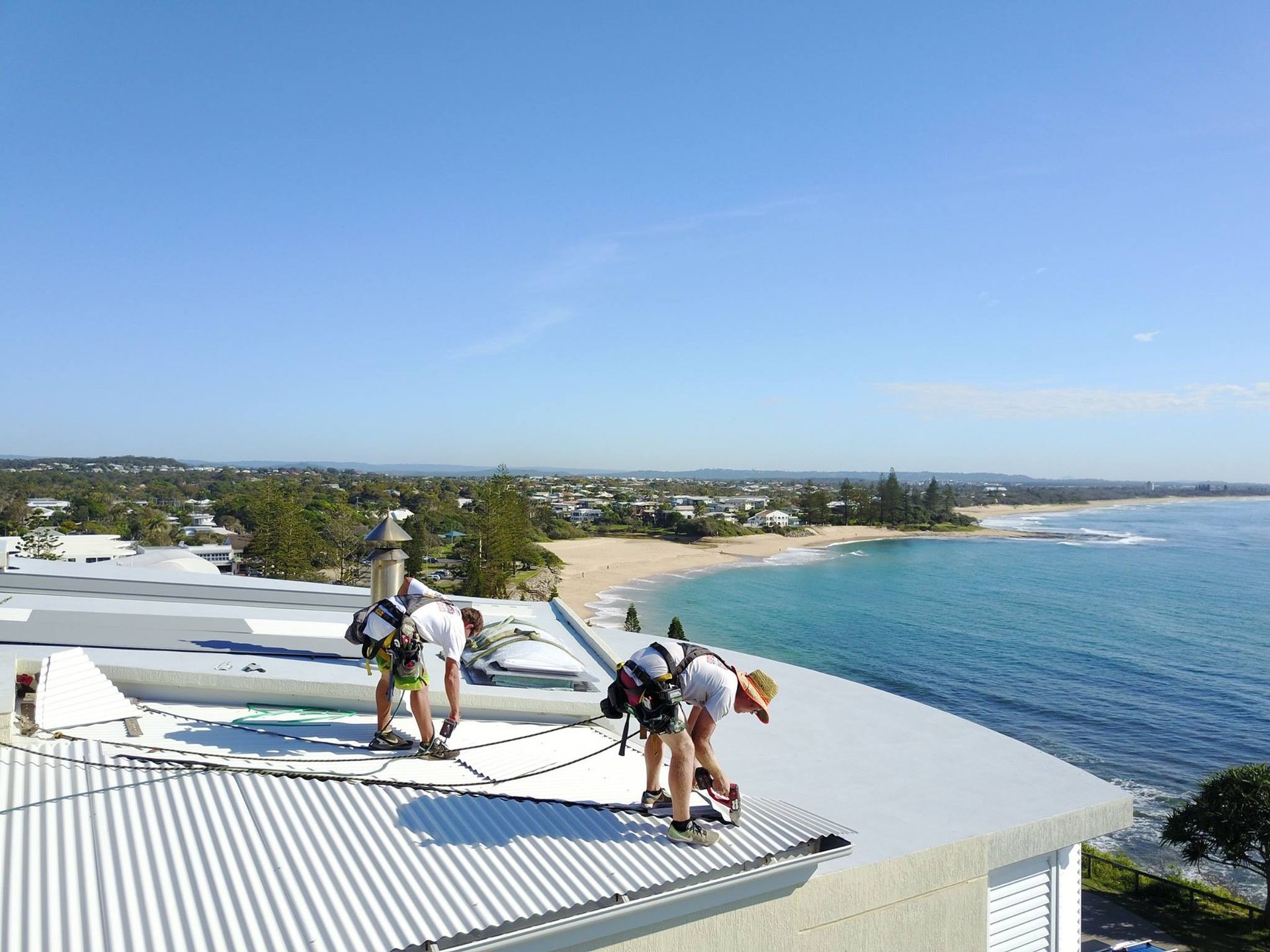 Metal Roof Being Maintained by Two Roofers