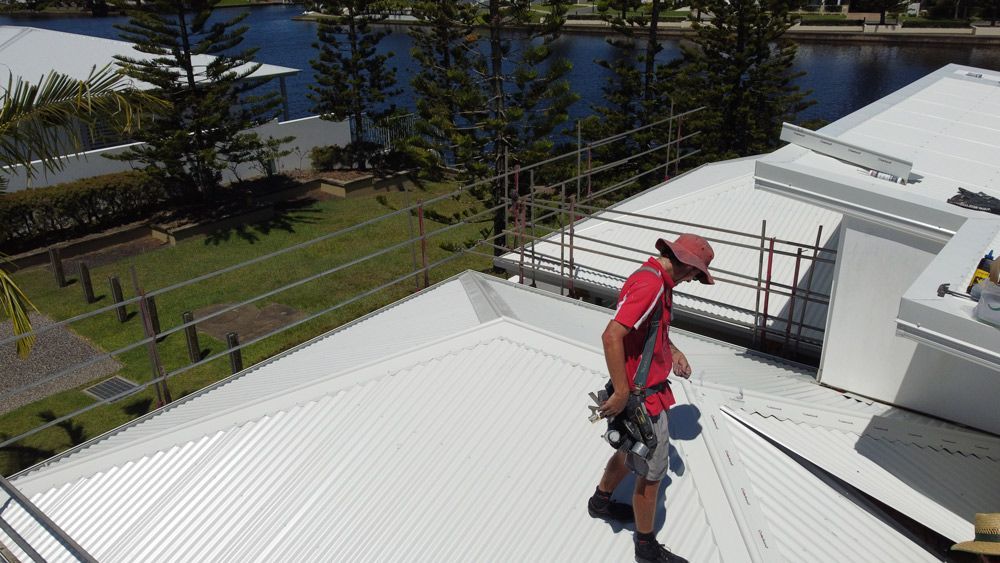 Roofer Inspecting Roof After Storm
