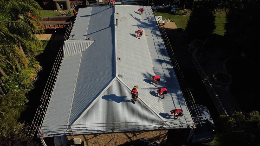 A team of professionals completing a roof restoration project