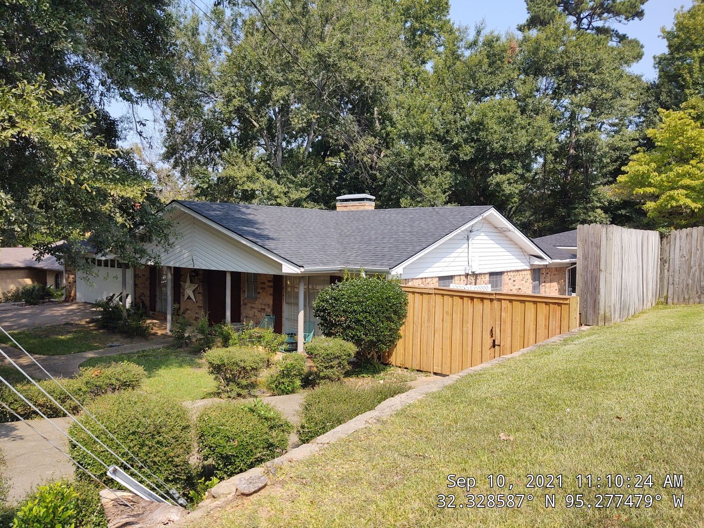 A house with a wooden fence in front of it