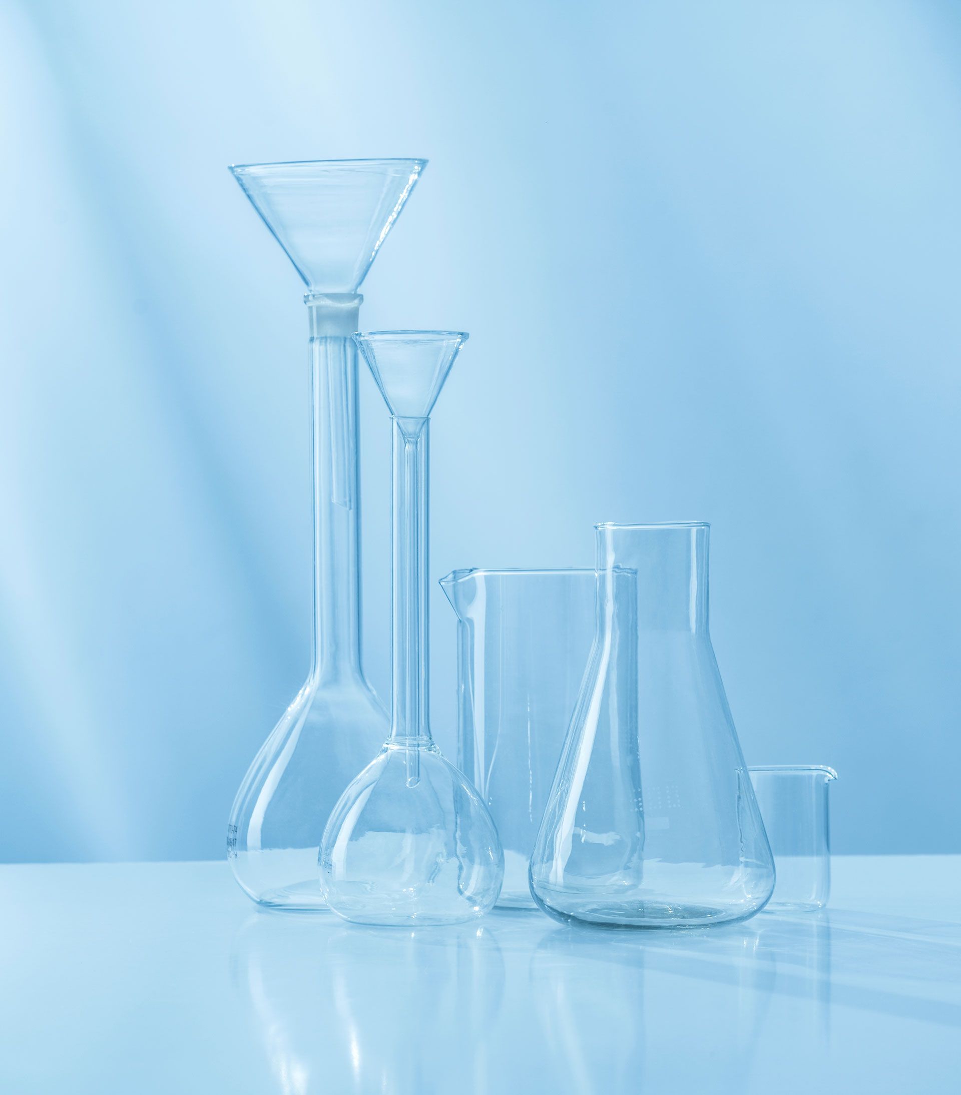 There are many different types of beakers on the table.