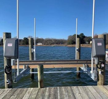 A group of men are working on a large pipe in a factory.
