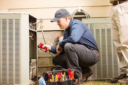 Repair Man Touching a HVAC Remote — Air Condition in Portsmouth, VA