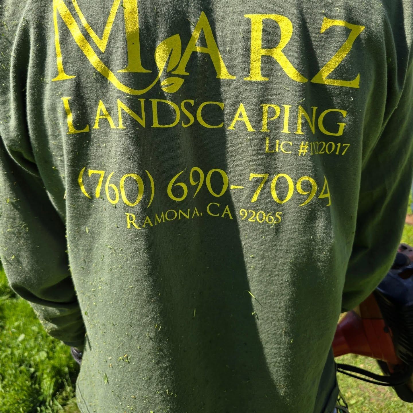 Person wearing a green shirt with yellow 