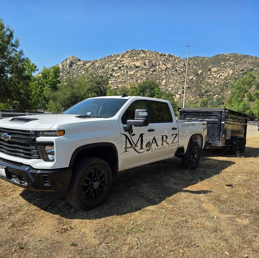 White pickup truck with black trailer, logo 
