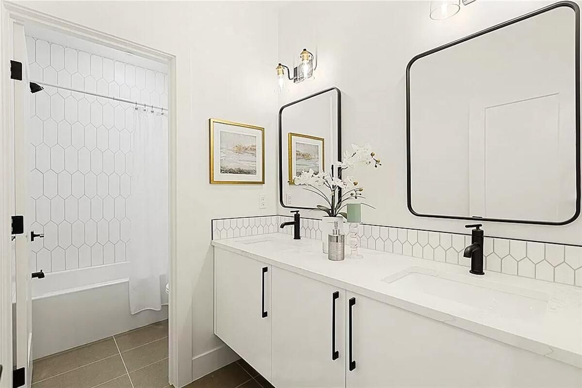 A bathroom with two sinks and two mirrors.