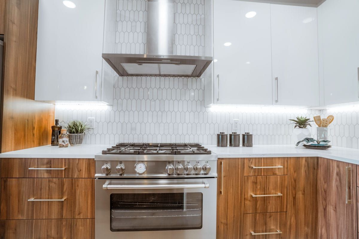 A kitchen with stainless steel appliances and wooden cabinets.