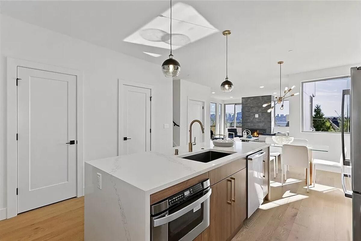 A kitchen with stainless steel appliances and a large island.