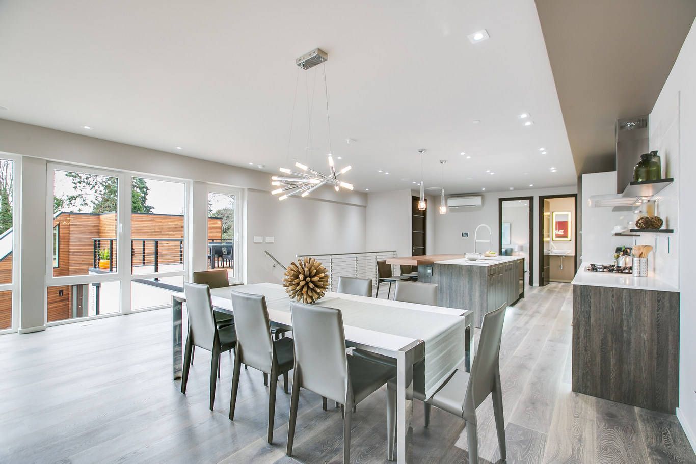 There is a dining table and chairs in the middle of the room.