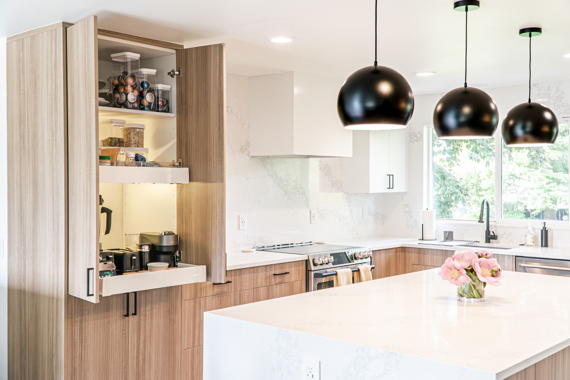 A kitchen with wooden cabinets , white counter tops , stainless steel appliances and a large island.