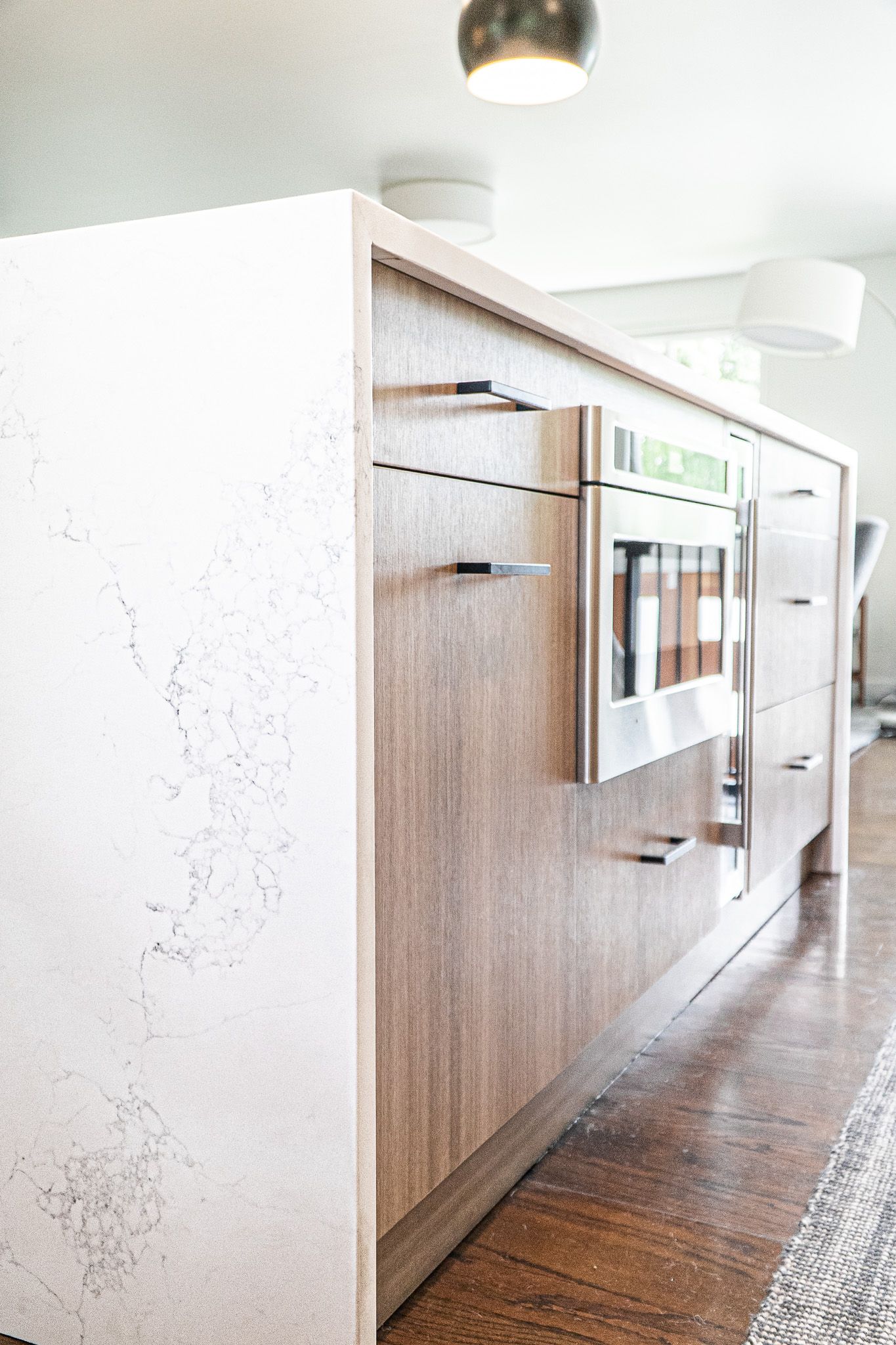 A kitchen with wooden cabinets and a stainless steel oven.