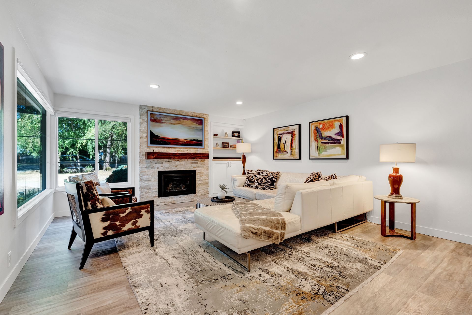 A living room with a couch , chairs , and a fireplace.