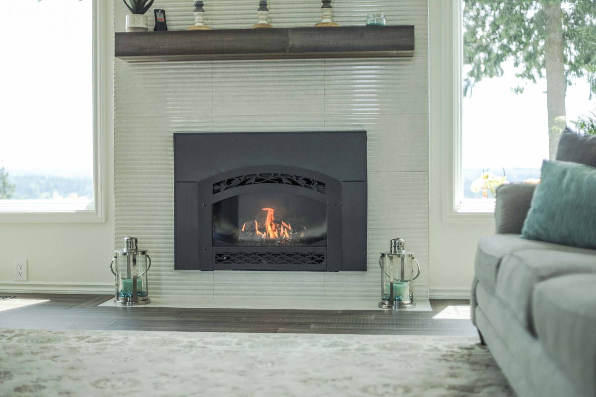 A living room with a fireplace and a couch.