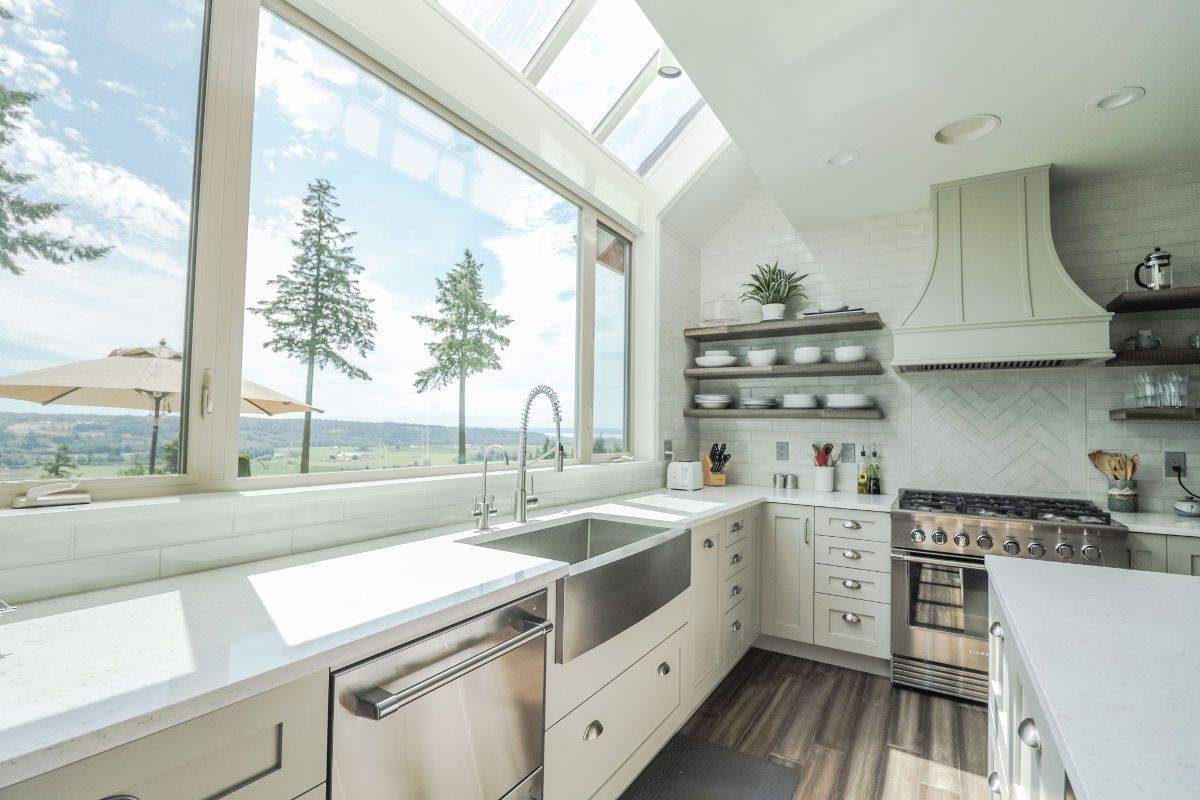 A kitchen with a large window and a sink.