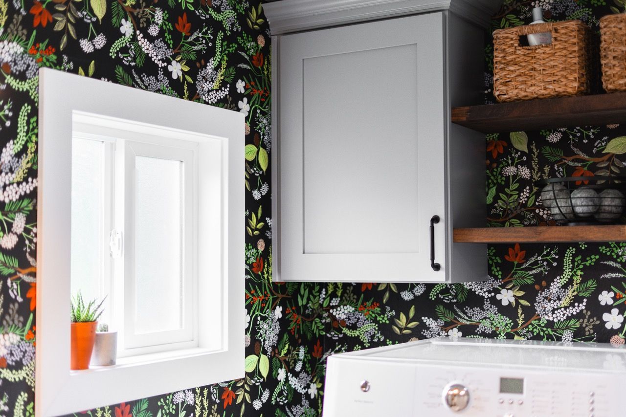 A laundry room with a washer and dryer and a window.