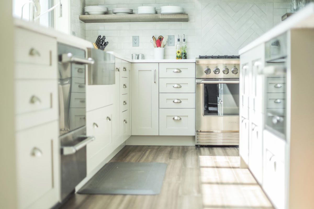 A kitchen with white cabinets and stainless steel appliances