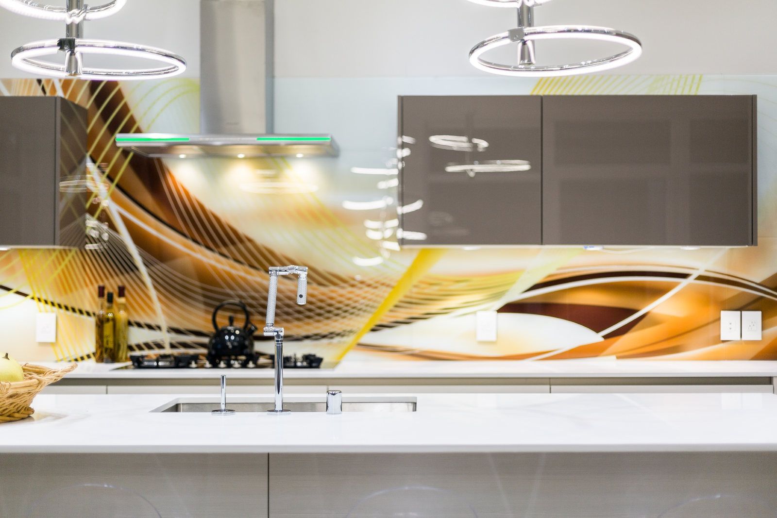 A kitchen with a sink , stove , and a painting on the wall.