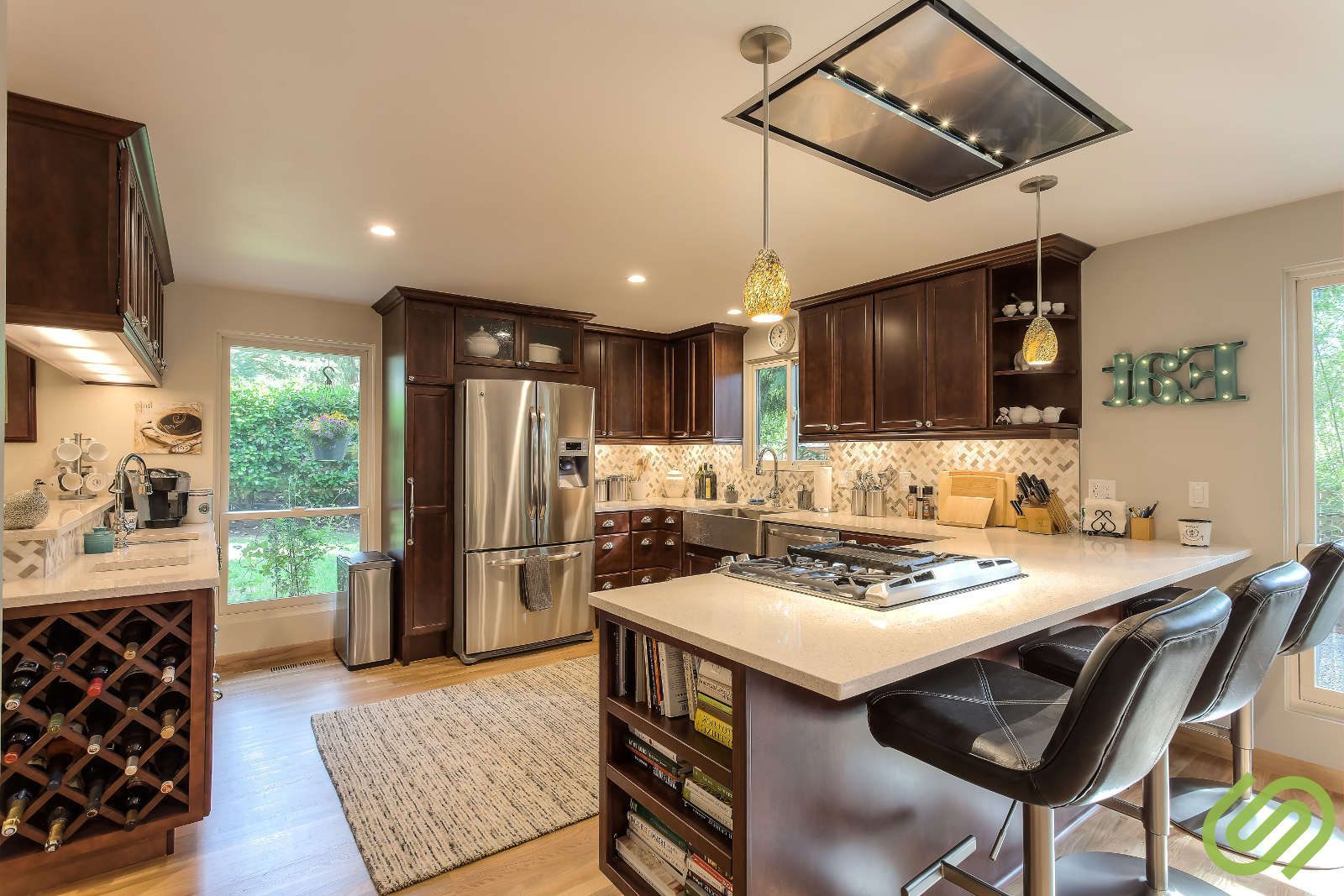 A kitchen with stainless steel appliances and wooden cabinets.
