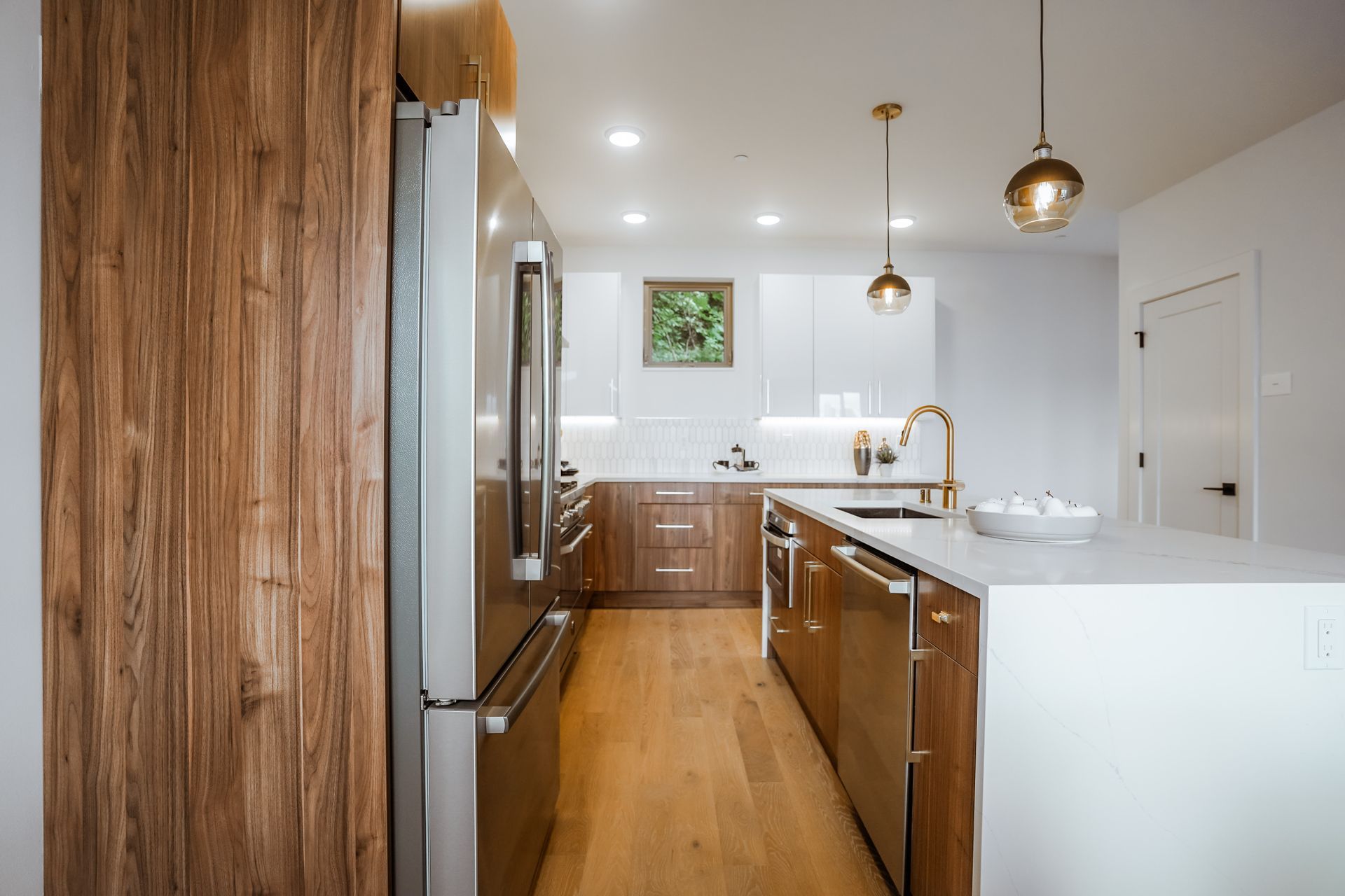 A kitchen with stainless steel appliances and wooden cabinets.